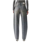 A pair of wide-leg, high-waisted gray denim jeans shown from the back on a model, featuring a faded wash and a small white brand patch on the back waistband.