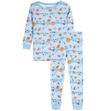 A two-piece children's pajama set with a light blue background and an all-over sports print featuring soccer balls, basketballs, footballs, and a basketball hoop. The set includes a long-sleeve top and matching pants, shown against a plain white background.