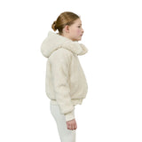 A young girl in profile wearing a cream-colored sherpa fleece hooded jacket and matching cream pants, photographed against a solid white background.