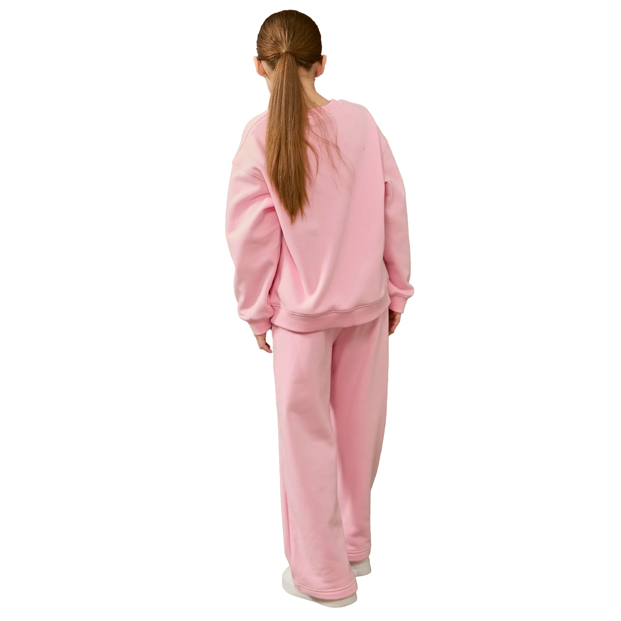 A girl viewed from behind wearing a matching light pink sweatshirt and sweatpants set, standing against a plain white background.