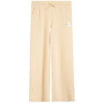 A pair of light beige ribbed knit pants with a drawstring waist and a small white brand patch on the left thigh, shown against a plain white background.