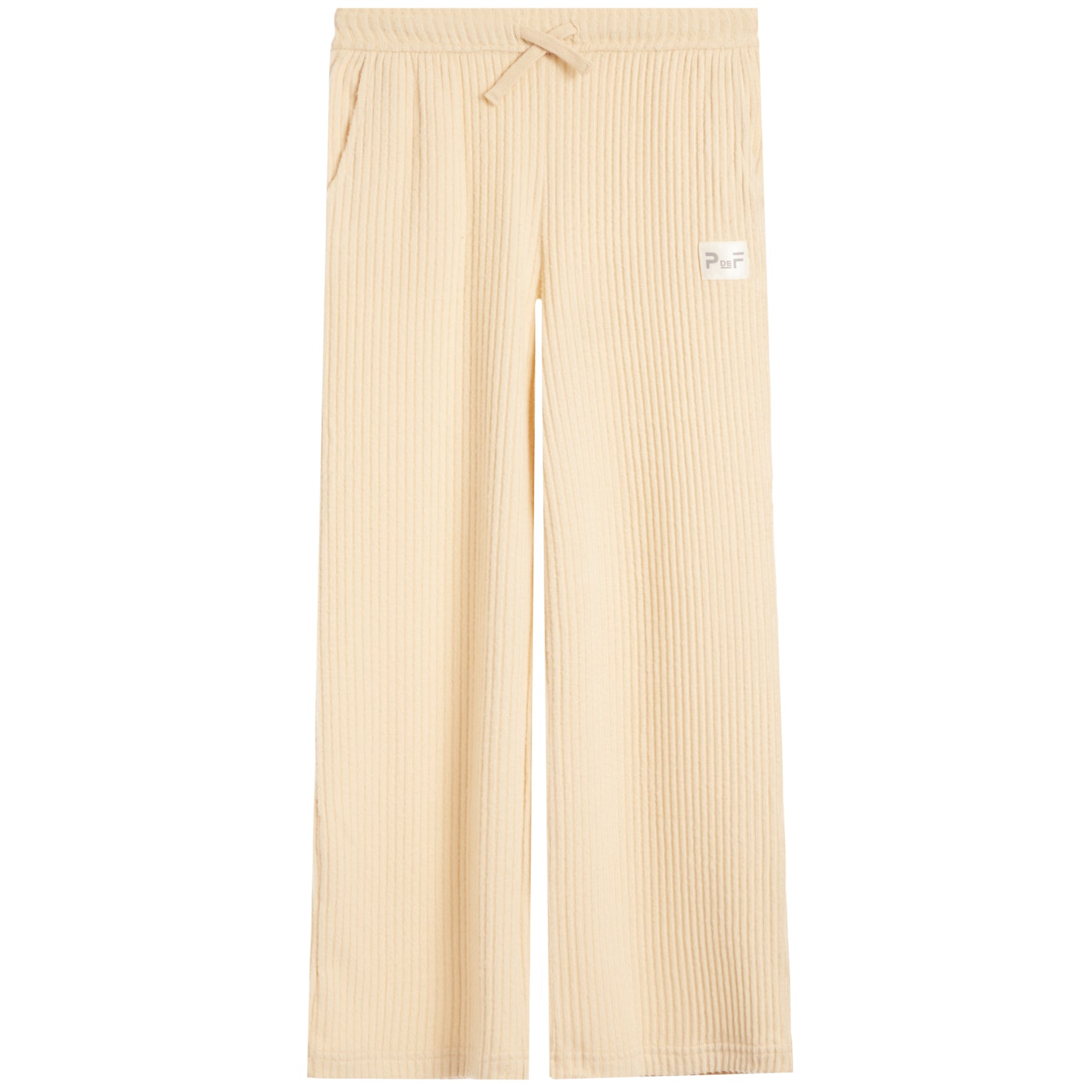 A pair of light beige ribbed knit pants with a drawstring waist and a small white brand patch on the left thigh, shown against a plain white background.