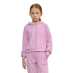 A young girl with red hair in a ponytail wearing a pink ribbed knit hooded sweatshirt and matching sweatpants, standing against a solid white background.