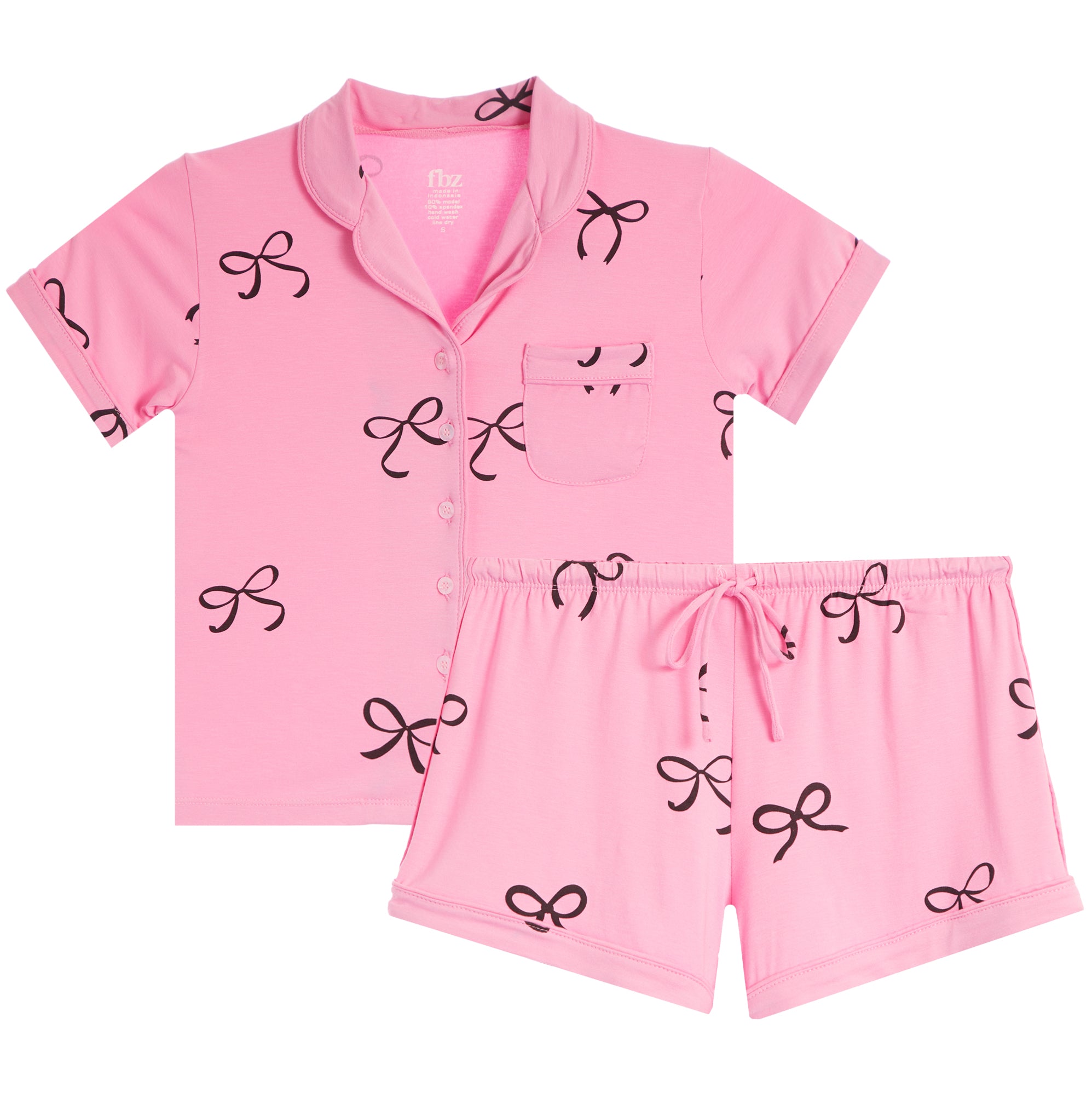 A two-piece baby pajama set in pink, featuring a short-sleeve button-front top with a chest pocket and matching shorts, both decorated with a black bow pattern, shown on a plain white background.
