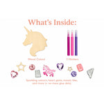 Unicorn craft kit contents on a white background, including a wooden unicorn cutout, three pink and purple markers, unicorn and heart gem stickers, a glitter star, a glitter tile, and no-mess glue dots. Text at the top reads 'What's Inside:'.