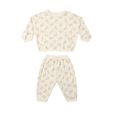 A two-piece baby loungewear set consisting of a long-sleeve top and matching pants in cream with a small beige floral pattern, displayed on a solid white background.