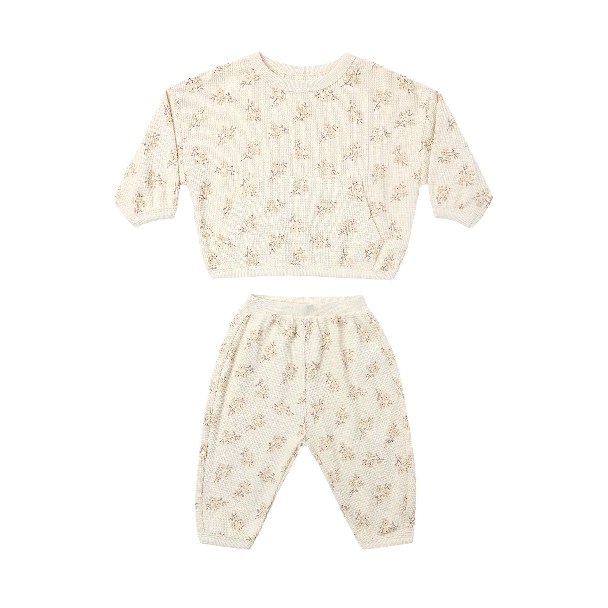 A two-piece baby loungewear set consisting of a long-sleeve top and matching pants in cream with a small beige floral pattern, displayed on a solid white background.