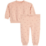 A two-piece children's sweatshirt and jogger pants set in a soft peach-pink color, featuring a small repeating pink heart pattern and a drawstring waist on the pants.