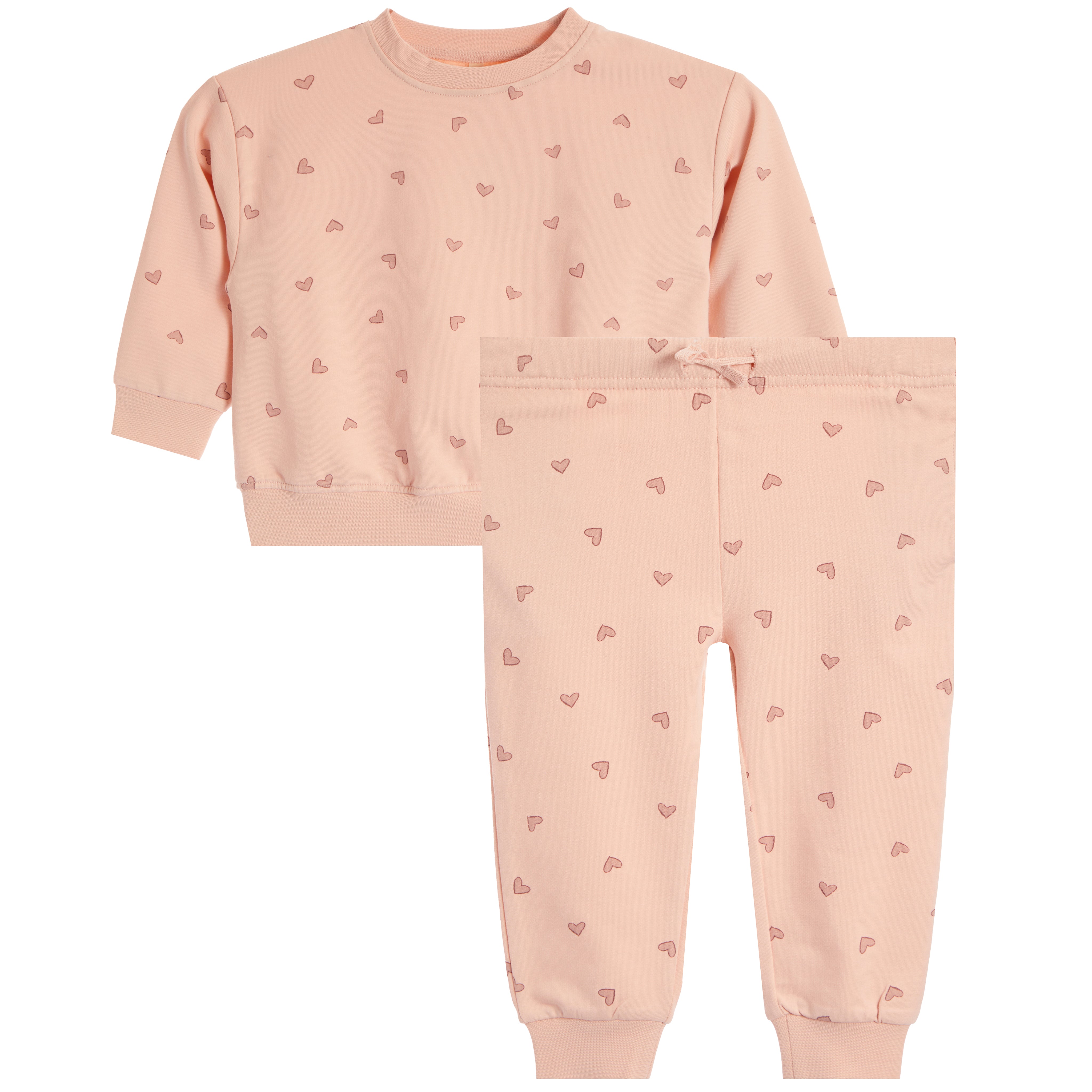 A two-piece children's sweatshirt and jogger pants set in a soft peach-pink color, featuring a small repeating pink heart pattern and a drawstring waist on the pants.