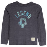 A toddler's long-sleeve t-shirt in dark heather gray, featuring a distressed blue graphic on the front with the word 'LEGEND' above a soccer ball, and a small beige brand patch near the bottom right hem.