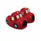A pair of red plush slippers shaped like fire trucks, featuring black wheels, yellow details, and white window frames, set against a plain white background.
