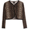 A cropped long-sleeve cardigan featuring a brown and beige leopard print pattern with black lace trim along the V-neck, button closure, cuffs, and hem.