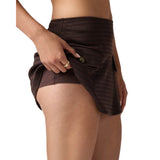 A close-up of a model wearing dark brown textured shorts with a side button closure, shown against a plain white background.
