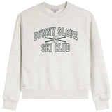 A light heather gray crewneck sweatshirt featuring the text 'BUNNY SLOPE SKI CLUB' in dark green varsity-style lettering with crossed skis and a bunny logo on the chest.