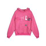 A pink heathered hoodie sweatshirt featuring the text 'Boys Lie' across the chest in stylized white, pink, and navy blue lettering, with a front kangaroo pocket and a small black logo patch on the pocket.