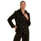 A woman modeling a black oversized blazer-style jacket with a built-in hood, front buttons, flap pockets, and matching black pants against a plain white studio background.