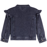A dark washed denim jacket shown from the back, featuring ruffled detailing on the shoulders and buttoned cuffs, set against a plain white background.