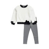 A children's two-piece outfit set featuring a fuzzy off-white long-sleeve top with black trim and bow details on the cuffs and hem, paired with black and white gingham checkered pants, shown against a plain white background.