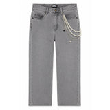 Gray denim jeans with a decorative pearl chain and small silver charms hanging from the right pocket, shown flat against a white background.