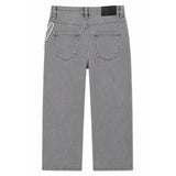 Back view of a pair of gray denim jeans featuring a decorative silver beaded chain detail on the left side of the back pocket.