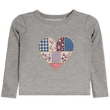 A gray long-sleeve baby t-shirt with a colorful patchwork heart design on the chest, featuring various floral and geometric fabric patterns.