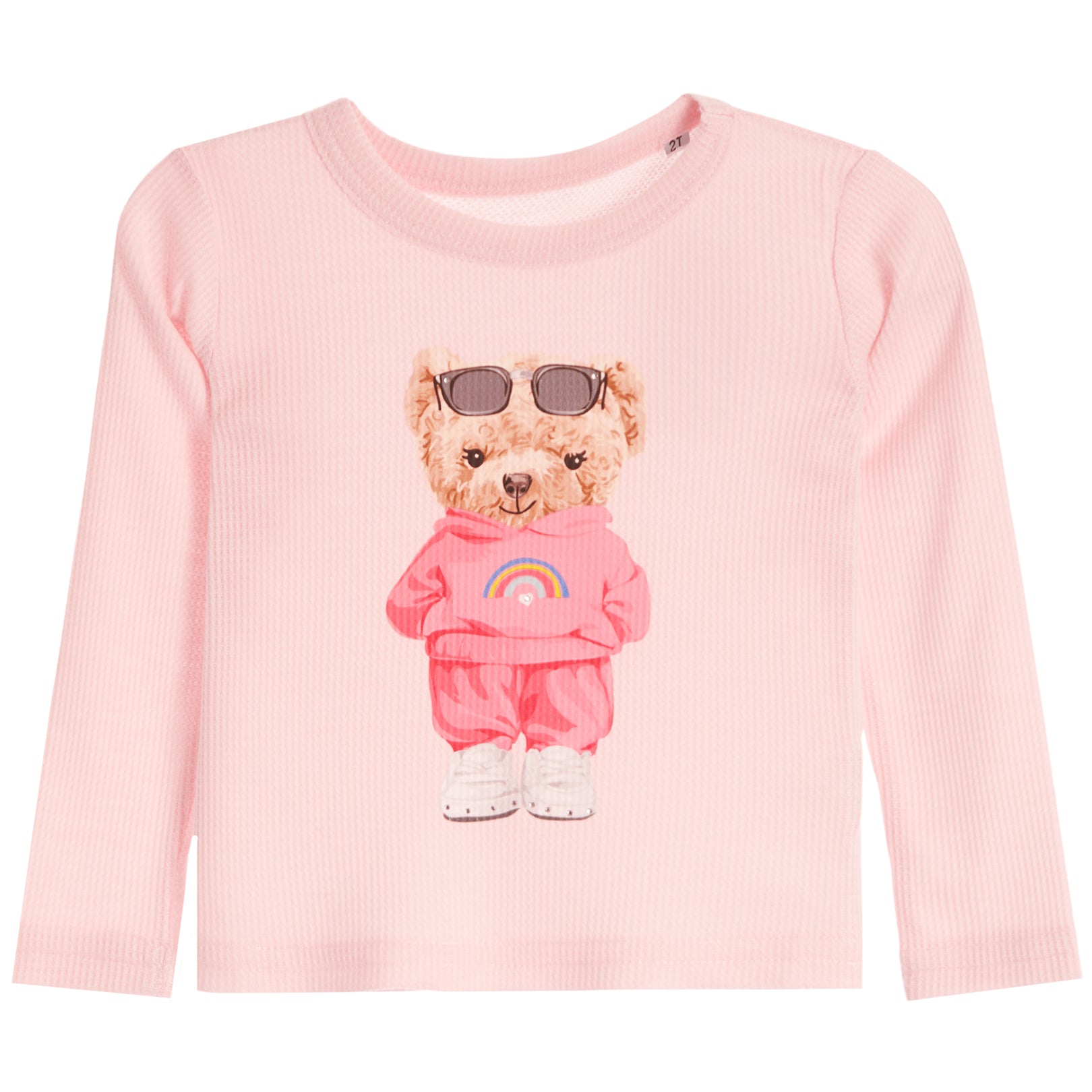 A light pink ribbed long-sleeve top featuring a cartoon teddy bear graphic wearing sunglasses, a pink hoodie with a rainbow, and white sneakers on the front, displayed against a solid white background.