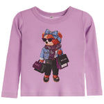 A lavender long-sleeve waffle-knit top for kids, featuring a central graphic of a teddy bear dressed in denim and holding shopping bags with 'PARIS' and 'MILAN' text.