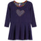 A navy long-sleeve knit dress with a scalloped multicolor neckline and a heart-shaped rhinestone embellishment on the chest, shown against a plain white background.