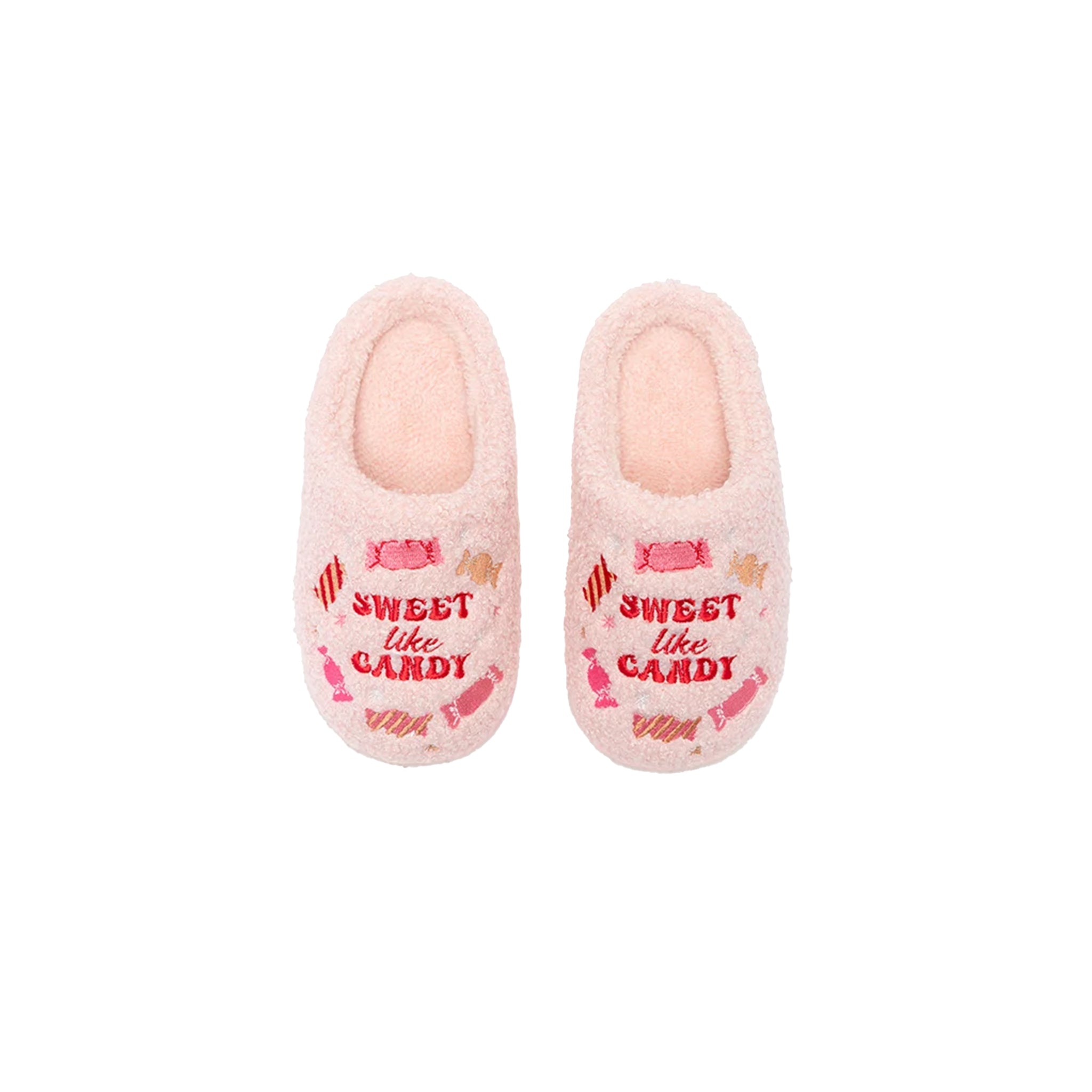 A pair of plush pink slipper shoes with 'SWEET like CANDY' embroidered in red on the front, decorated with candy illustrations in pink, red, and orange.