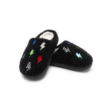 A pair of black fuzzy slip-on slippers with embroidered lightning bolts in multiple colors and small checkered patterns, shown on a plain white background.