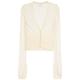 A cream-colored long-sleeve cardigan with a deep V-neckline, featuring a structured, slightly padded yoke and a sheer, lightweight fabric.