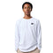 A young man wearing a white long-sleeve crewneck t-shirt with a small black stylized 'D' logo on the left chest, paired with beige pants, shot against a solid white background.