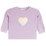 A lavender waffle-knit long-sleeve baby shirt with a central iridescent pastel heart patch, shown flat on a white background.
