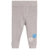 Light gray heathered knit baby pants with two small patches on the lower legs, one blue and one white.