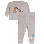 A toddler's two-piece heather gray sweatshirt and jogger pants set. The sweatshirt features a colorful graphic of a sneaker decorated with peace signs.