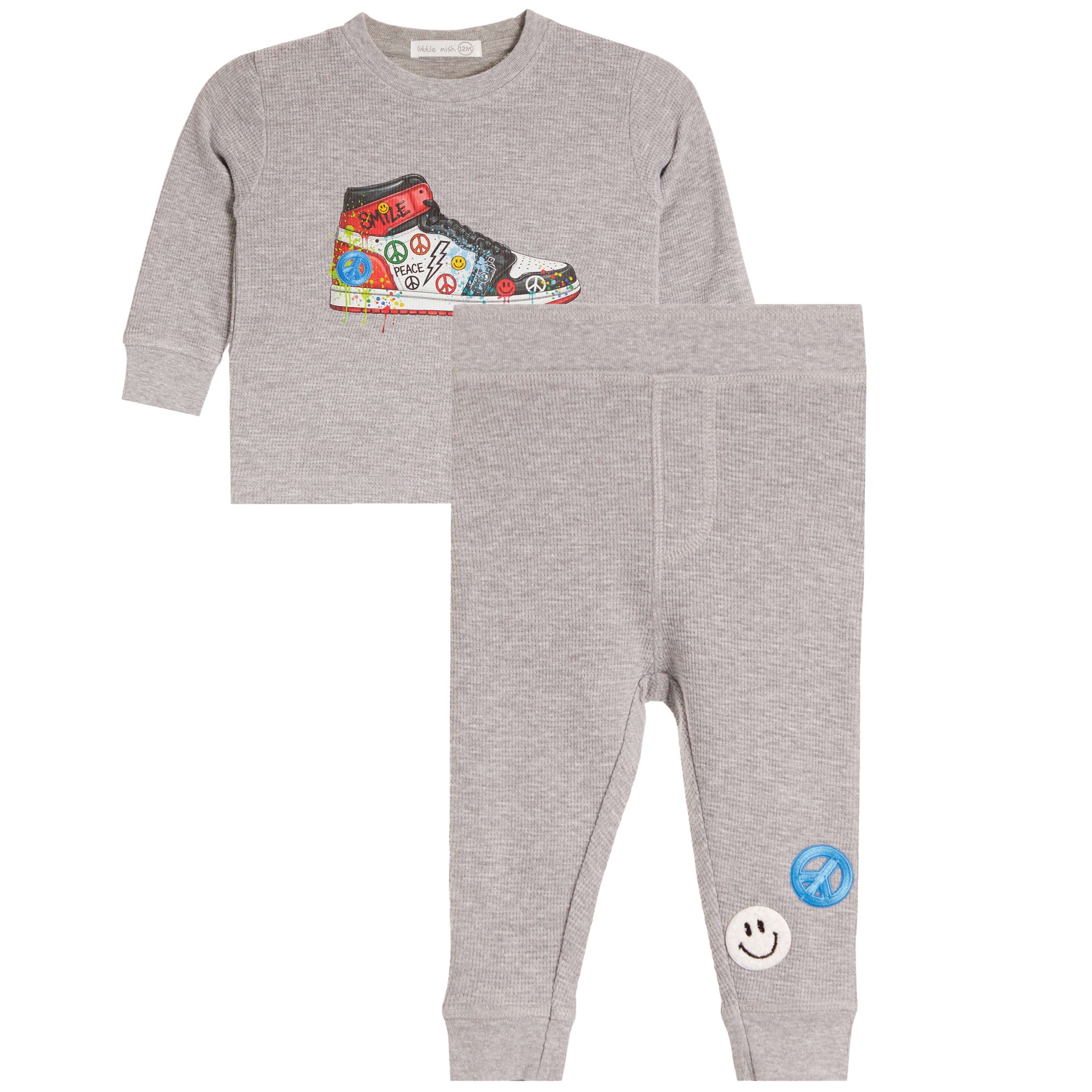 A toddler's two-piece heather gray sweatshirt and jogger pants set. The sweatshirt features a colorful graphic of a sneaker decorated with peace signs.