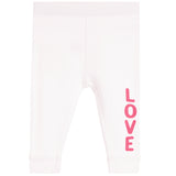 White ribbed knit baby leggings with the word 'LOVE' printed vertically in pink on the lower left leg, shown against a plain white background.
