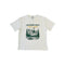 An off-white short-sleeve t-shirt with a graphic print of a mountain landscape and the text 'JACKSON HOLE Alpine Nights' on the front, displayed flat against a white background.