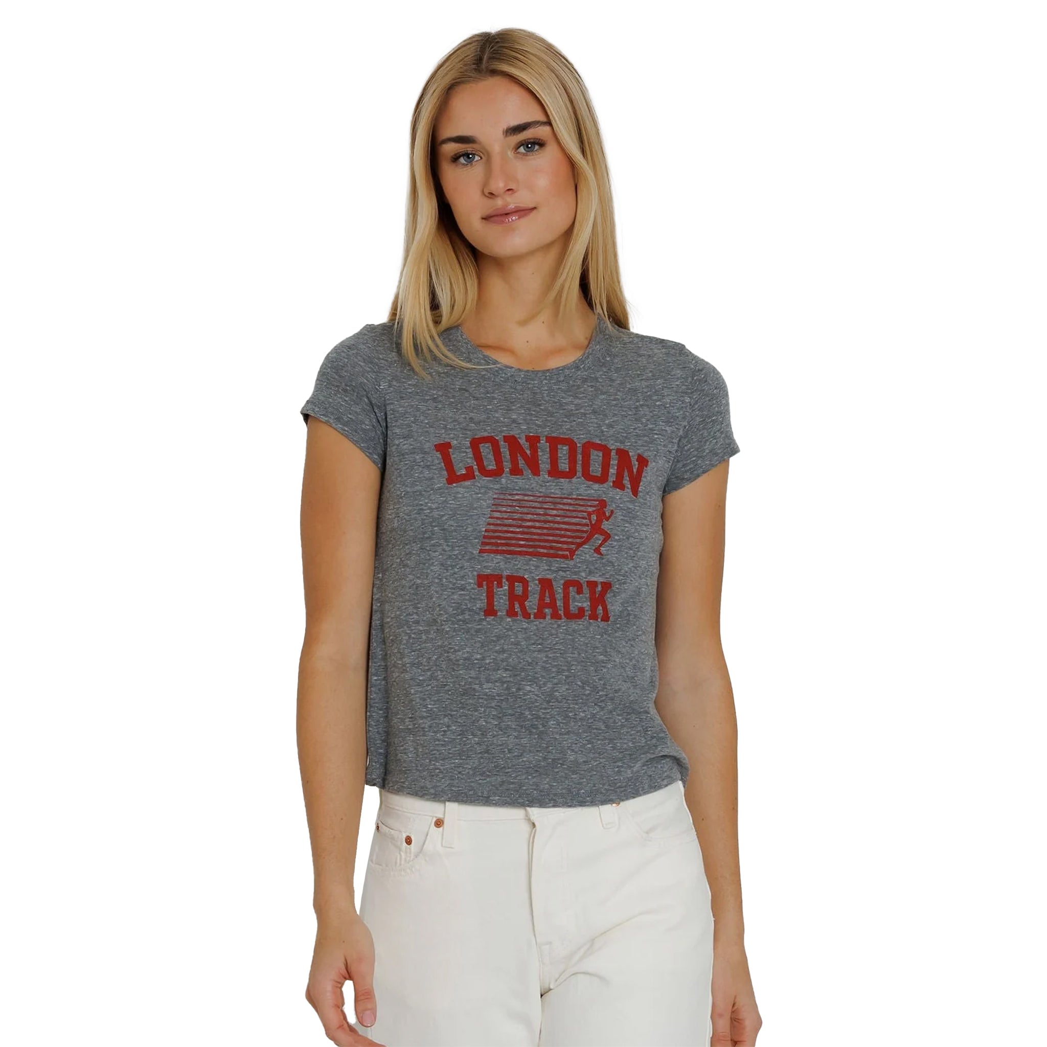 A woman modeling a heather gray cropped t-shirt with a red distressed 'LONDON TRACK' graphic on the front, paired with white pants, against a plain white background.
