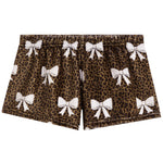 A pair of women's shorts featuring a brown leopard print pattern with white bow motifs repeated across the fabric, shown against a plain white background.