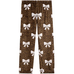 A pair of children's leggings featuring a brown leopard print pattern with white bow motifs repeated all over the fabric, shown flat against a solid white background.