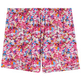 A pair of pajama shorts featuring an all-over multicolor abstract pattern with pink, blue, orange, and white shapes, set against a plain white background.