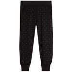 Black jogger pants with a delicate white polka dot pattern, featuring an elastic waistband and ribbed ankle cuffs, shown flat on a white background.
