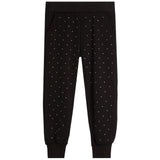 Black jogger pants with a delicate white polka dot pattern, featuring an elastic waistband and ribbed ankle cuffs, shown flat on a white background.
