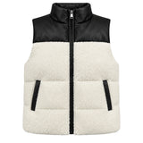 A colorblock puffer vest with a black faux-leather upper panel and collar, and a cream sherpa fleece lower body, featuring a front zipper and zippered hand pockets.