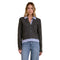 A woman modeling a dark charcoal cable-knit zip-front cardigan with light blue shirt-collar and hem details against a plain white background.