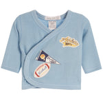 A light blue waffle-knit baby wrap shirt by Little Meek, featuring embroidered sports patches including a 'Athletics DEPT.' patch and a football patch on the front.