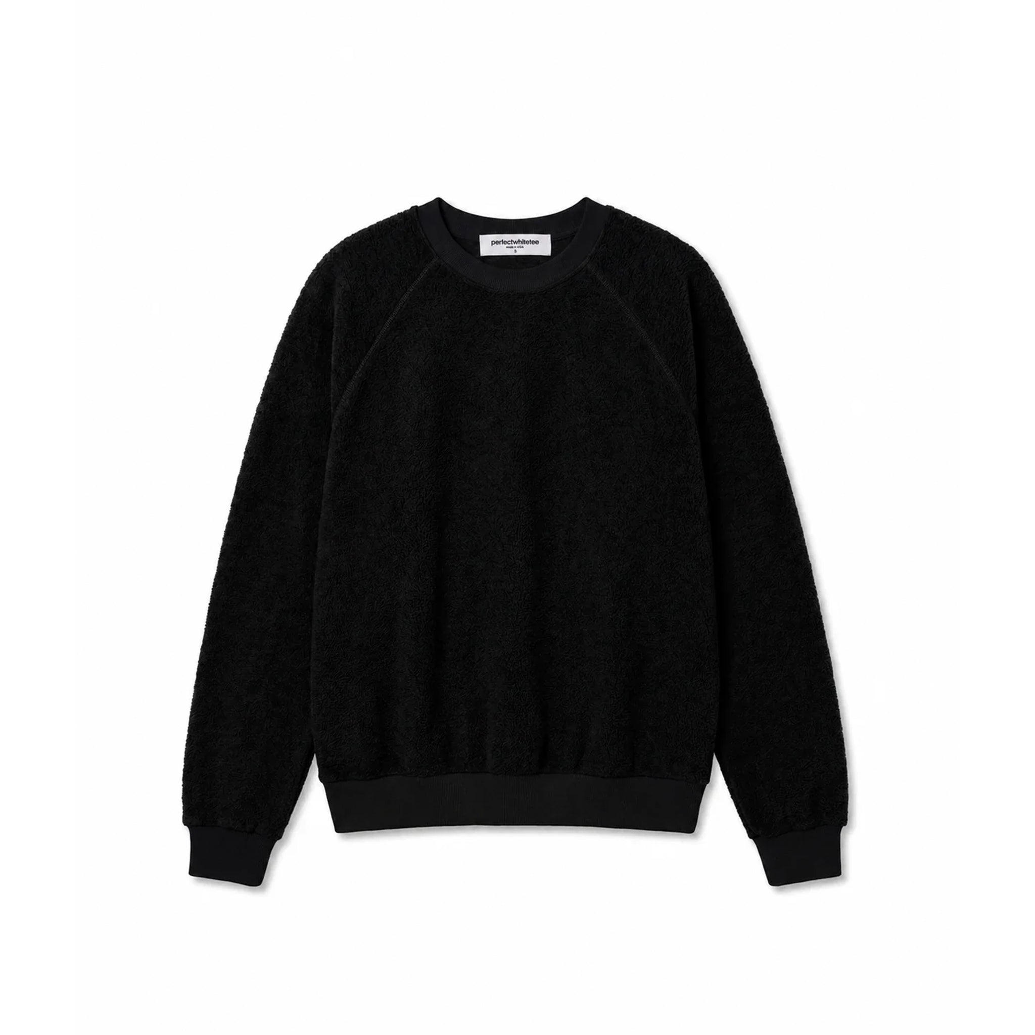 A black crewneck sweatshirt with raglan sleeves, laid flat against a solid white background.