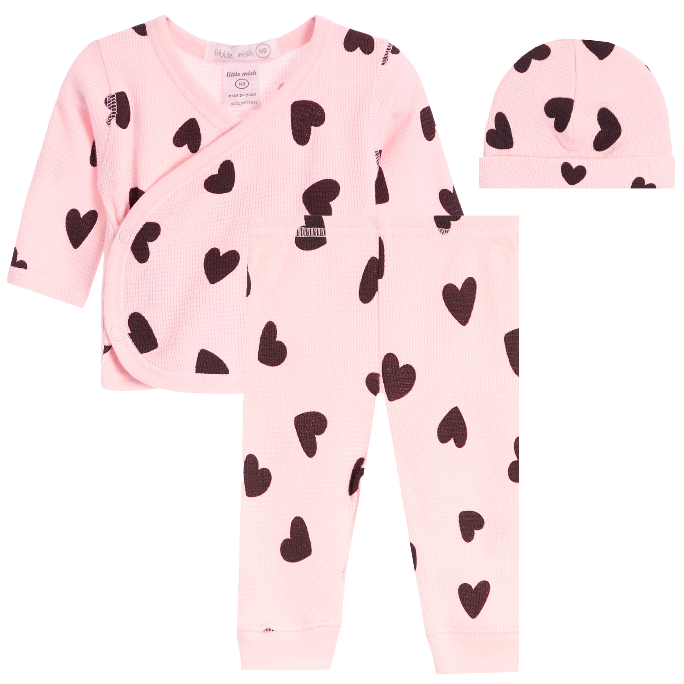 A three-piece baby clothing set including a long-sleeve wrap top, matching pants, and a beanie hat, all in light pink with a black heart pattern, displayed on a solid white background.