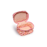 A small quilted cosmetic pouch with a pink and red lip print exterior and a peach-colored interior, shown open on a white background.